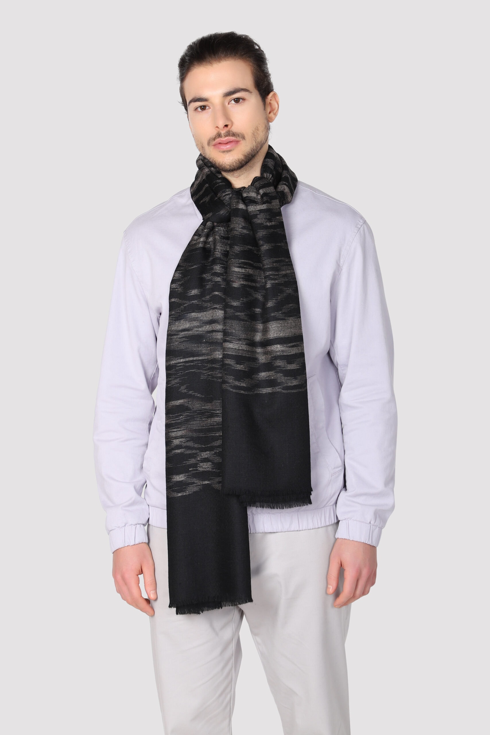 Model in Ikat cashmere shawl with grey colored shades scattered all over the black surface - MeandK