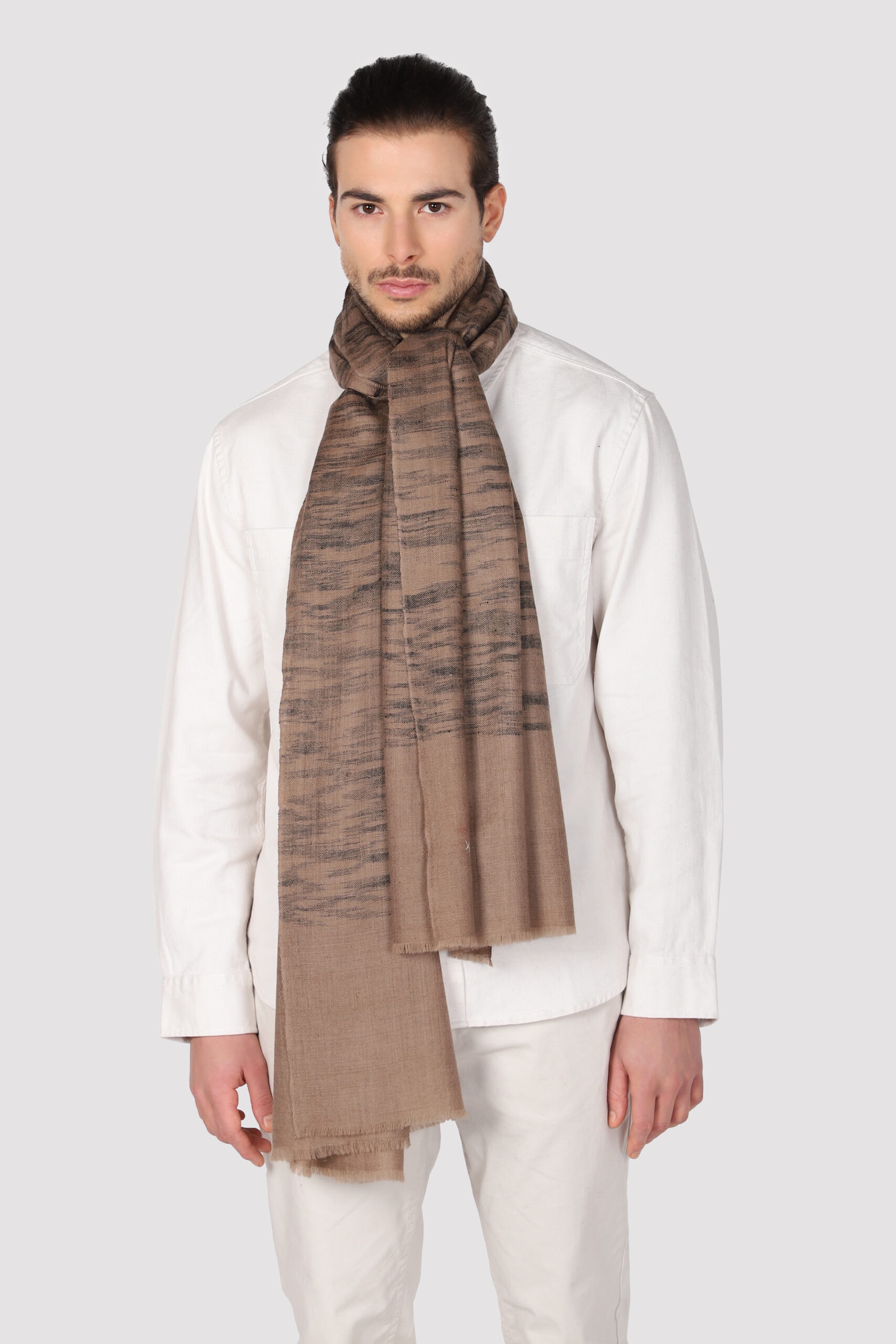 A male model in Ikat shawl with black colored shades scatterred all over the brown surface - MeandK