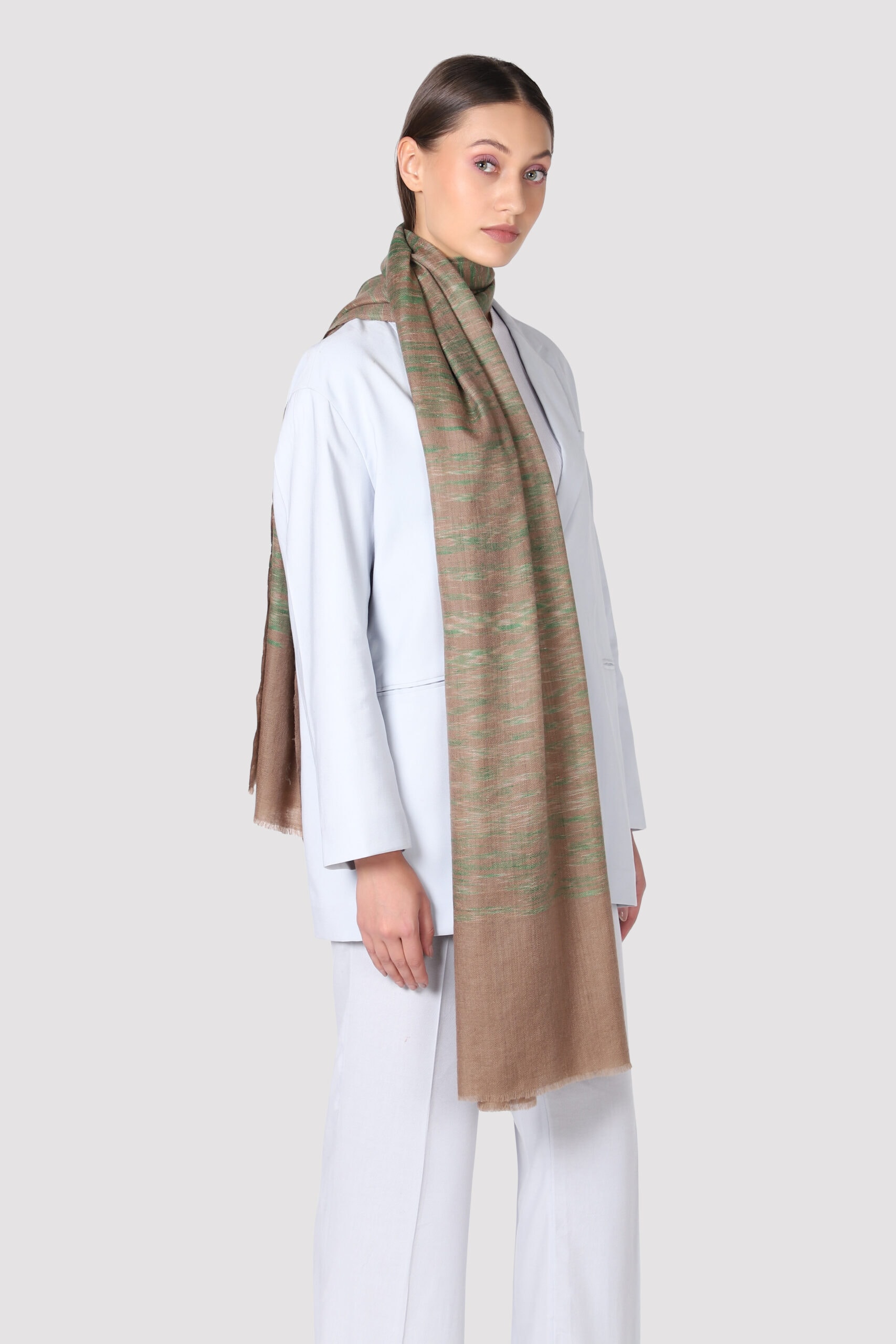 Woman in side pose wearing natural brown and green shaded Ikat shawl - MeandK