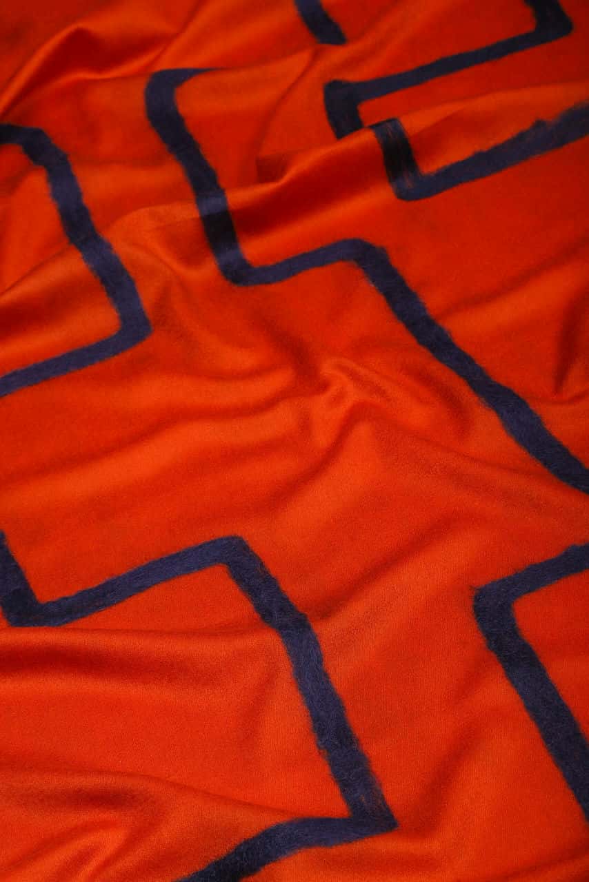 Close-up shot of muddle scarf in orange hue - MeandK